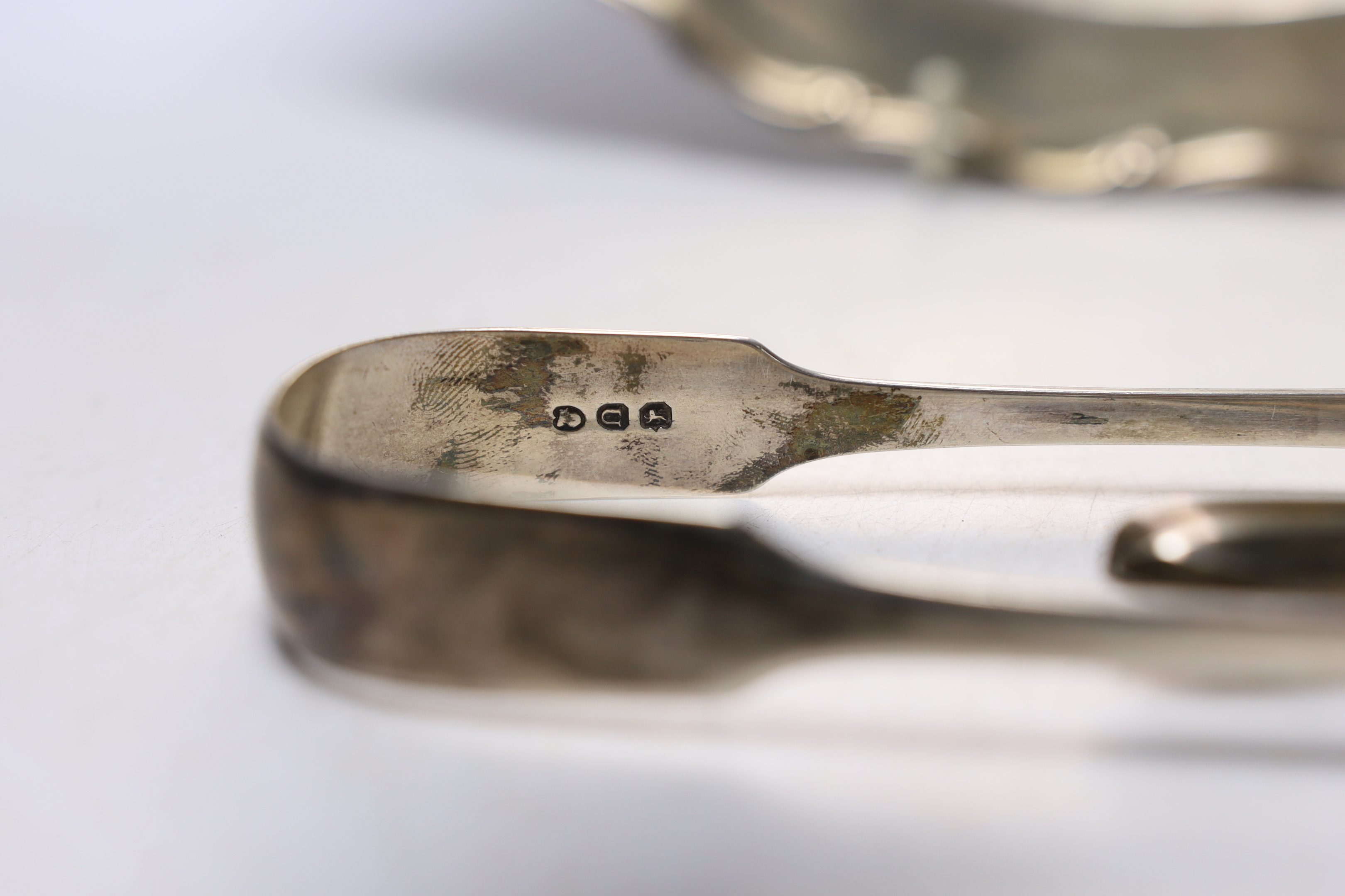 A 20th century Mexican 925 sterling circular platter, 30.1cm, a pair of Georgian silver sugar tongs and a later pair of silver grape shears, 26oz.